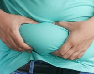 a man holding his stomach with his hands